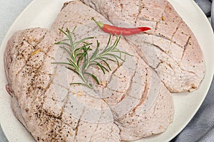 Raw duck breast with fresh spices and herbs, ready to cook food. Domestic cuisine, poultry meat