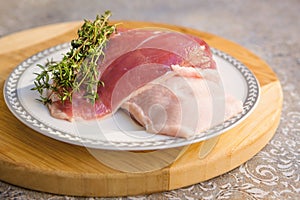 Raw duck breast with fresh thyme