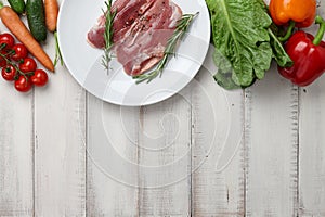 Raw duck breast in white plate and vegetables