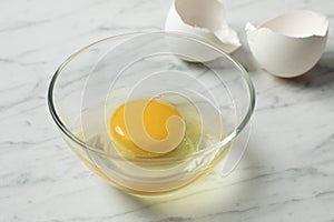 Raw egg in a bowl close up