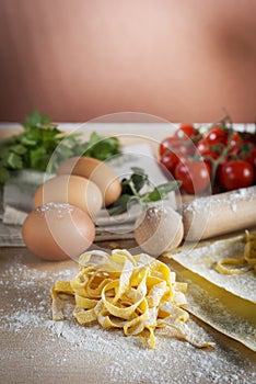 Raw egg pasta with flour and rolling pin photo