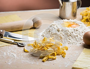 Raw egg pasta with flour and rolling pin photo