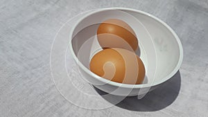 Raw egg or telur in indonesian on bowl on white background