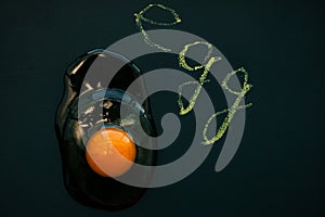 Raw egg yolk on black background