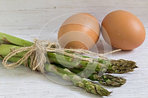 Raw eggs and asparagus, healthy breakfast, ingredients for cooking