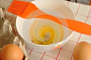 Raw eggs in box and egg yolk with spices