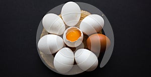 Raw eggs in the form of a daisy on a dark background