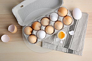 Raw eggs in package on table