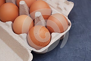 Raw farm eggs on a Dark Blue Wooden Rustic Background.