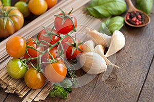 Raw fettuccine pasta, vegetables and herbs