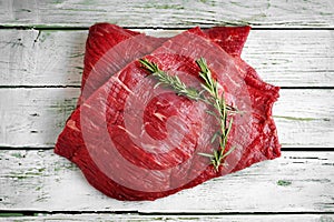 Raw fillet of beef brisket on white wooden background