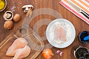 Raw fillet. Cooking Chicken. Bread with flour, starch and spices. Lemon, fresh champignons, onions, garlic, wine, salt