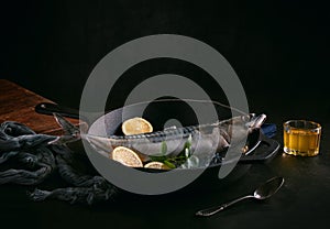 Raw fish presented in a metal dish