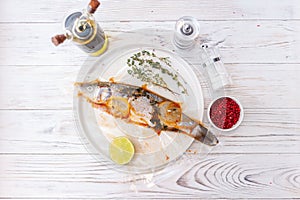 Raw fish sea bass with spices and herbs ingredients on white background