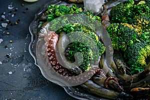 Raw fish and seafood with vegetables, close view, selective focus