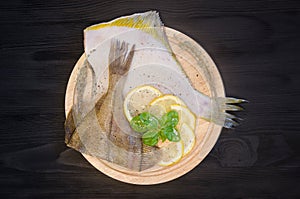 Raw fish sole round board lemon basil