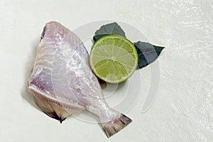 Raw fish, on white stone, ready to be seasoned photo