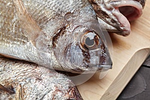 Raw fish on wooden cutting board