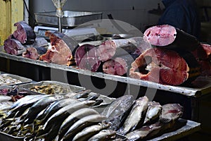 Raw fishes on fish market stall on street