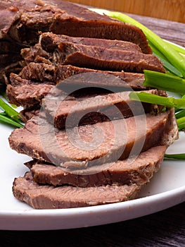 raw five pork or beef tongues with green onion, on wooden background gourment food conception, selective focus