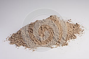 Raw flax seeds flour on white background