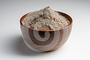 Raw flax seeds flour in a wooden bowl with on white background.