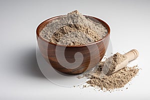 Raw flax seeds flour in a wooden bowl with on white background.