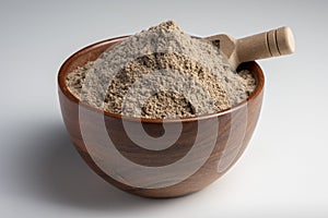 Raw flax seeds flour in a wooden bowl with on white background