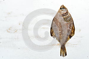 Raw flounder fish with spices. Seafood on a white wooden background.