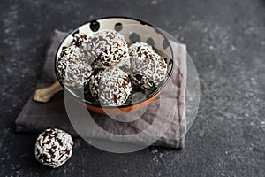 Raw food balls from nuts and dates on a black background