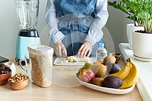 Raw foodism,Woman cutting banana for blender, dietary plant based eating for vegan or vegetarian