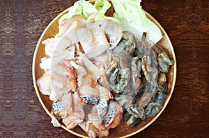 Closeup of Fresh squid, pacific white shrimp and fish
