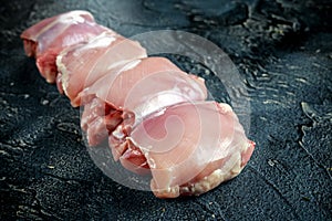 Raw Free range Boneless skinless chicken thighs on stone table photo