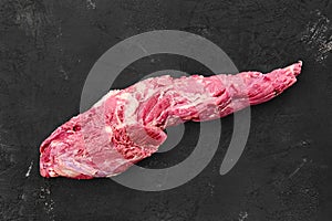 Raw fresh beef whole tenderloin on black photo