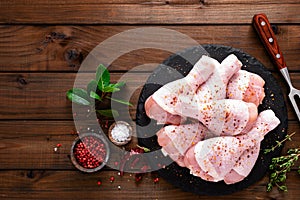 Raw fresh chicken legs on wooden background. Top view