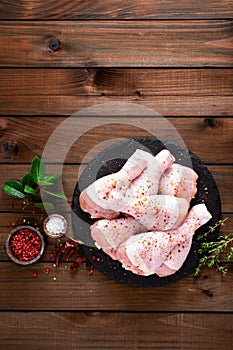 Raw fresh chicken legs on wooden background. Top view