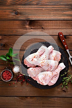 Raw fresh chicken legs on wooden background. Top view