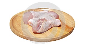 Raw fresh chicken wings or drumsticks chicken on a wooden plate isolated on white background with clipping path. side view