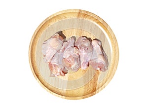 Raw fresh chicken wings on a wooden plate. isolated on white background with clipping path. Top view