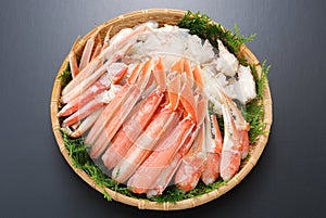 Raw fresh cold snow crab pot set with claws, legs, meat and herb