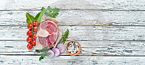 Raw fresh cross cut veal shank with spices and herbs on a white background. Cheese Bif steak Ossbo. Top view.