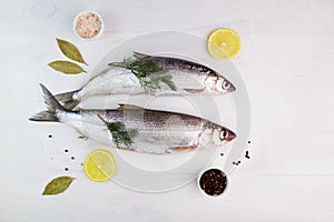 Raw fresh fish with spices and ingredients for cooking on a white background. Baikal Omul