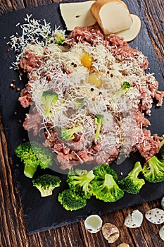 Raw fresh forcemeat with broccoli and cheese