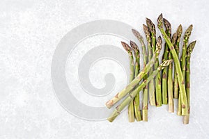 Raw and Fresh Green Asparagus Stems on Gray Background