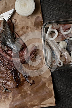 raw fresh herring and giblets in the paper bag, preparation to salt fish