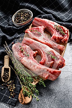 Raw fresh lamb ribs with pepper and thyme. Organic meat. White background. Top view