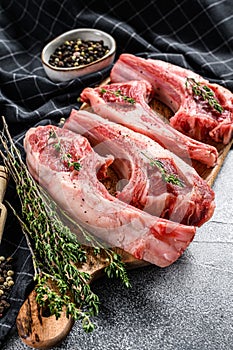 Raw fresh lamb ribs and spicy herbs. White background. Top view