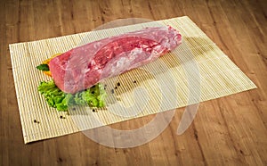 Raw fresh meat medallions with vegetables on black board and clipping path