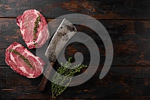 Raw fresh meat Ribeye steak entrecote of Black Angus, on old dark  wooden table background, top view flat lay, with copy space for