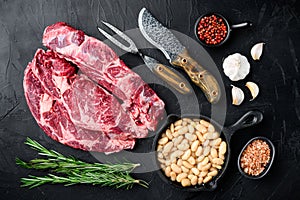 Raw fresh meat Ribeye steak entrecote of Black Angus Prime meat with ingredients, on black stone background, top view flat lay